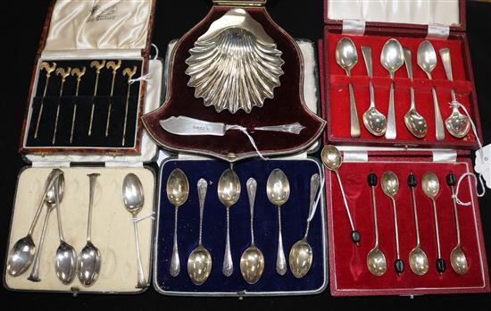 A cased silver butter dish and knife set, 3 sets of silver coffee spoons, a part set and 6 cocktail stirrers with cockerel finials